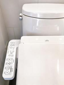 a toilet with a remote control next to it at Oceanfront Escape with Private Bath and Beach Access in Gibsons
