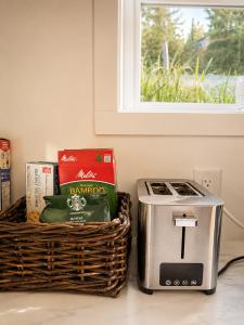 a basket of food next to a toaster at Oceanfront Escape with Private Bath and Beach Access in Gibsons +14 photos