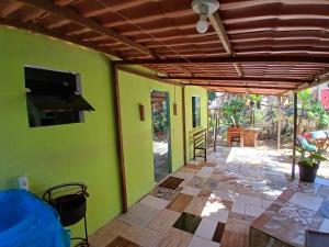 a living room with green walls and a flat screen tv at Aconchego Ebenézer in Praia de Provetá 