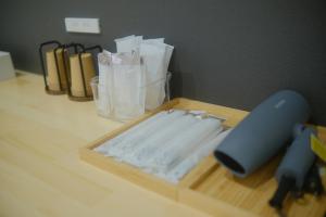 a wooden cutting board with a knife on a table at Private Stay EN SUMOTO in Sumoto