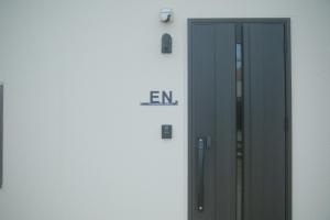 a door with the word en on the side of a building at Private Stay EN SUMOTO in Sumoto