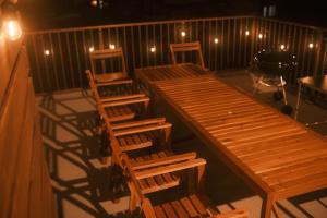 a deck with wooden tables and chairs and a piano at Private Stay EN SUMOTO in Sumoto +23 photos