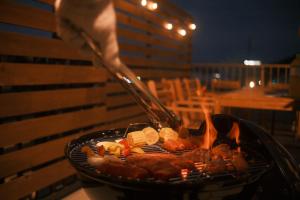 a person is cooking food on a grill at Private Stay EN SUMOTO in Sumoto