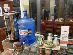 a large bottle of water sitting on a glass shelf at Los Portales de Chivay Hotel in Chivay +26 photos