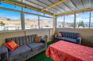 a living room with a couch and a table at Los Portales de Chivay Hotel in Chivay