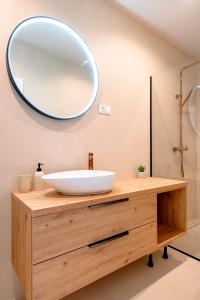 a bathroom sink with a large mirror on the wall at Providenca Residence Šibenik in Šibenik +99 photos