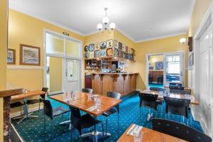 a restaurant with tables and chairs in a room at The Station in Hunterville