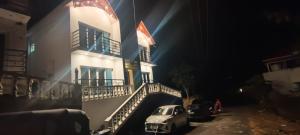 a car parked in front of a building at night at SAAI Rosorts iin Yercaud in Yercaud