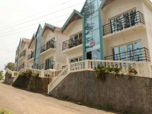 a large building with balconies on the side of it at SAAI Rosorts iin Yercaud in Yercaud