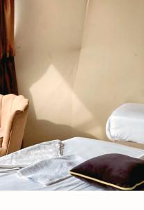 a bed with a blanket and a pillow on it at Wadi Rum Elara Luxury Camp in Wadi Rum