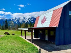a building with a canadian flag on the side of it at Hot Tub Nights & Mountain Mornings PÜR in Golden +12 photos