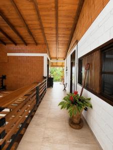 a hallway of a building with a wooden ceiling at La Cabaña Mr Brown in Puerto Leguízamo
