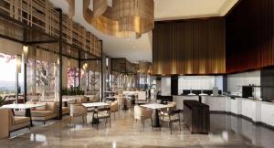 a restaurant with tables and chairs in a building at Manado Marriott Resort & Spa in Manado