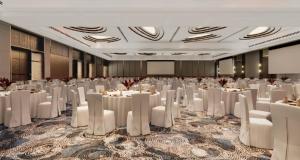 a banquet hall with white tables and white chairs at Manado Marriott Resort & Spa in Manado