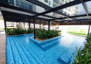 a swimming pool in the middle of a building at Trefoil Studio Unit Near Setia City Mall 1-5 Pax in Shah Alam
