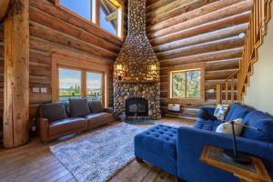 a living room with a blue couch and a fireplace at Adams Rest Cabin in The Dalles