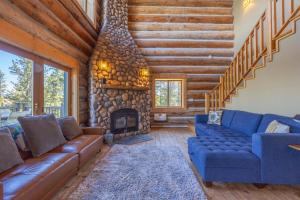 a living room with a couch and a fireplace at Adams Rest Cabin in The Dalles +43 photos