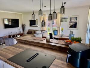 a living room with a couch and a table at Grodehus-Eigener-Bungalow in Haby