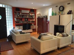 a living room with two couches and a fireplace at La Mansarda di Margherita in Treviso