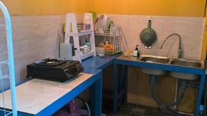 a kitchen with a sink and a counter with a sink at A-Manta Homestay in Labuan Bajo +84 photos