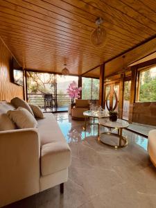 a living room with a couch and a table at Hotel Dorys de Lourdes in Pisco Elqui +151 photos