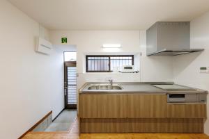 a kitchen with a sink and a counter top at あかねや in Marugame