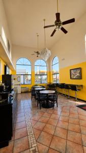 a dining room with tables and chairs and a ceiling fan at Economy Inn in Las Cruces