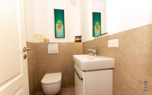 a bathroom with a toilet and a sink at Wattknistern in Garding +17 photos