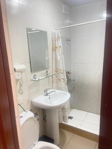 a bathroom with a sink and a toilet and a shower at GLOBUS Avenue Hotel in Yakkasaray +17 photos
