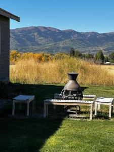 a picnic table with a pot sitting on top of it at 3 King Beds Spacious 4 BR 3 BATH AC Near Jackson in Victor