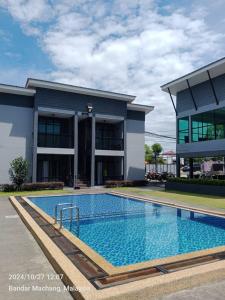 a swimming pool in front of a building at Enap Machang in Macang +20 photos