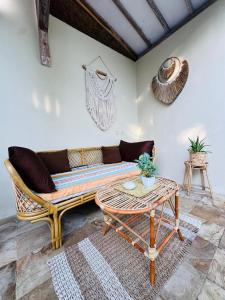 a living room with a couch and a table at Villa Sea La Vie Private pool in Gili Meno