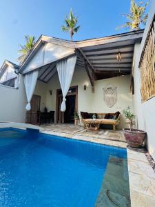 a villa with a swimming pool and a house at Villa Sea La Vie Private pool in Gili Meno