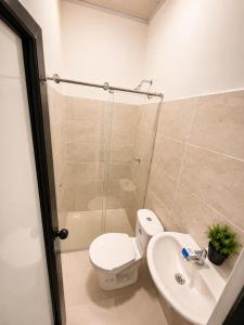 a bathroom with a toilet and a sink and a shower at hotel venus in Los Patios
