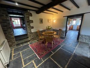 a dining room with a table and chairs at 16th Century Devon Farmhouse Stunning Views in Winkleigh