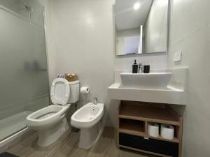a white bathroom with a sink and a toilet at Del Pino Park in Buenos Aires +25 photos