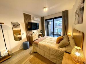 a bedroom with a bed and a television in it at Del Pino Park in Buenos Aires