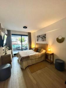 a bedroom with a bed and a large window at Del Pino Park in Buenos Aires