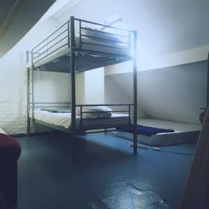 a bunk bed room with two bunk beds in a room at Trapmouse hostel in Brussels