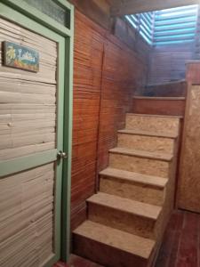 a set of stairs in a room with a door at dondelachatahostel in Máncora