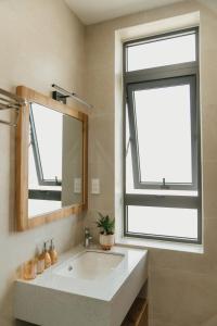 a bathroom with a large sink and a window at Minh An Villa in Da Thanh +60 photos