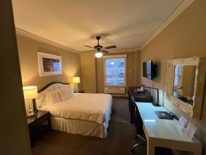 a hotel room with a bed and a desk at Kensington Park Hotel in San Francisco