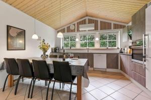 a kitchen with a table and chairs in a room at C11068-Hemmet-Vibevaenget-11 in Hemmet