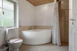 a white bathroom with a tub and a toilet at C11068-Hemmet-Vibevaenget-11 in Hemmet +34 photos