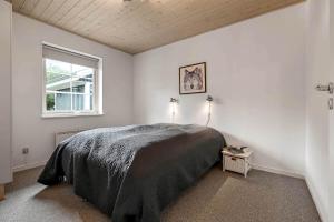 a bedroom with a bed and a window at C11068-Hemmet-Vibevaenget-11 in Hemmet