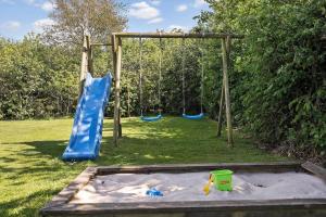 a playground with two swings in a yard at C11068-Hemmet-Vibevaenget-11 in Hemmet