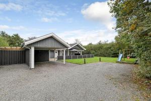 a house with a garage and a playground at C11068-Hemmet-Vibevaenget-11 in Hemmet