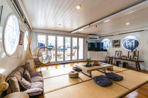 a living room with a couch and a table at Cipango - Hong Kong Houseboat in Hong Kong