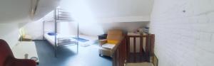 a small room with a couch and a staircase at Trapmouse hostel in Brussels
