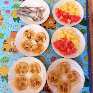 a table topped with plates of food and fruit at Nahla bungalows tetebatu in Tetebatu +35 photos